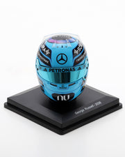 Blue 1:5 scale George Russell 2026 replica helmet with Mercedes branding and tinted visor on a black stand.